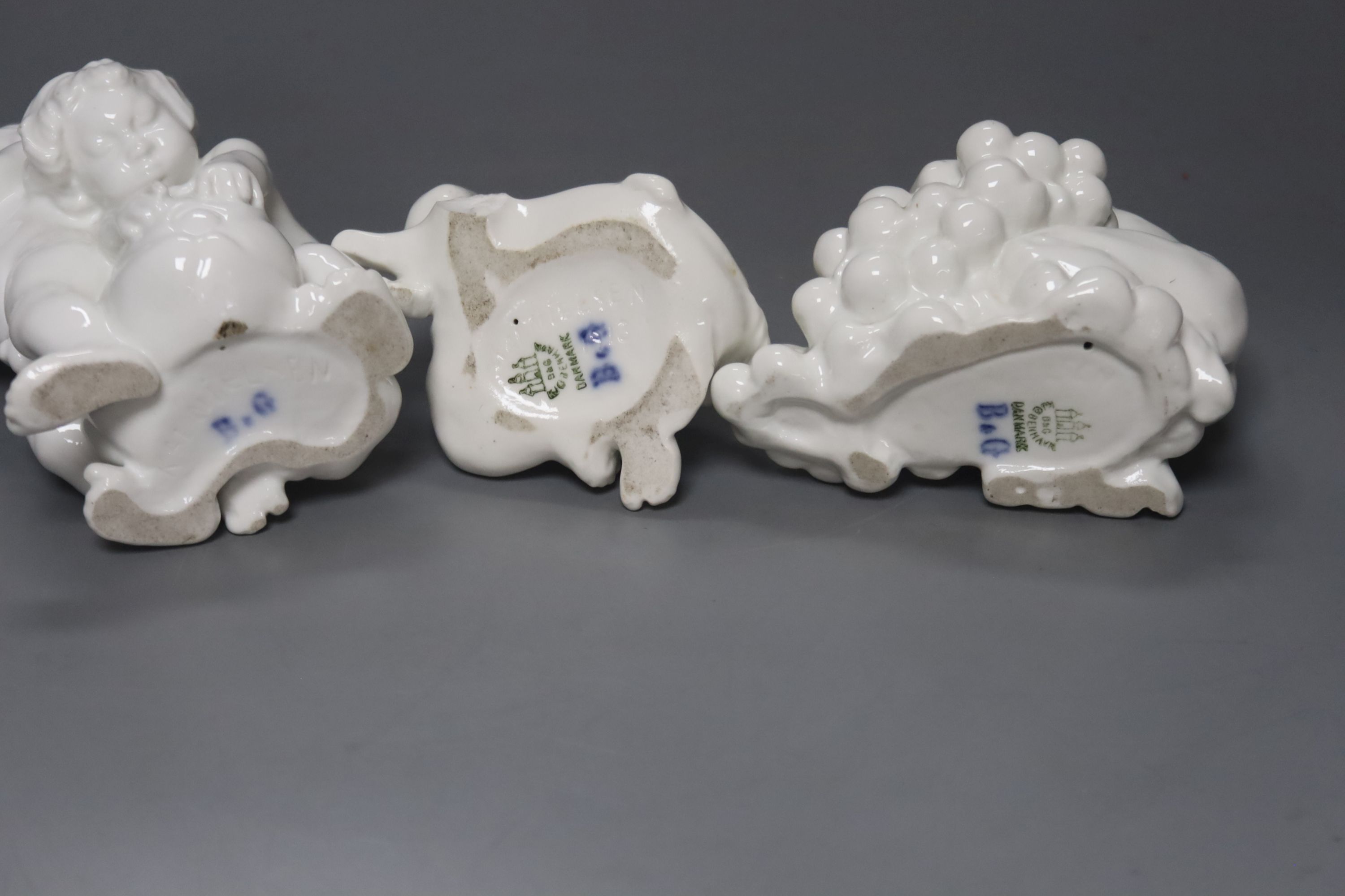 Kai Neilsen (1882-1924) for Bing & Grondahl, three white porcelain groups of children or cherubs, models 4021, 4033 and ?